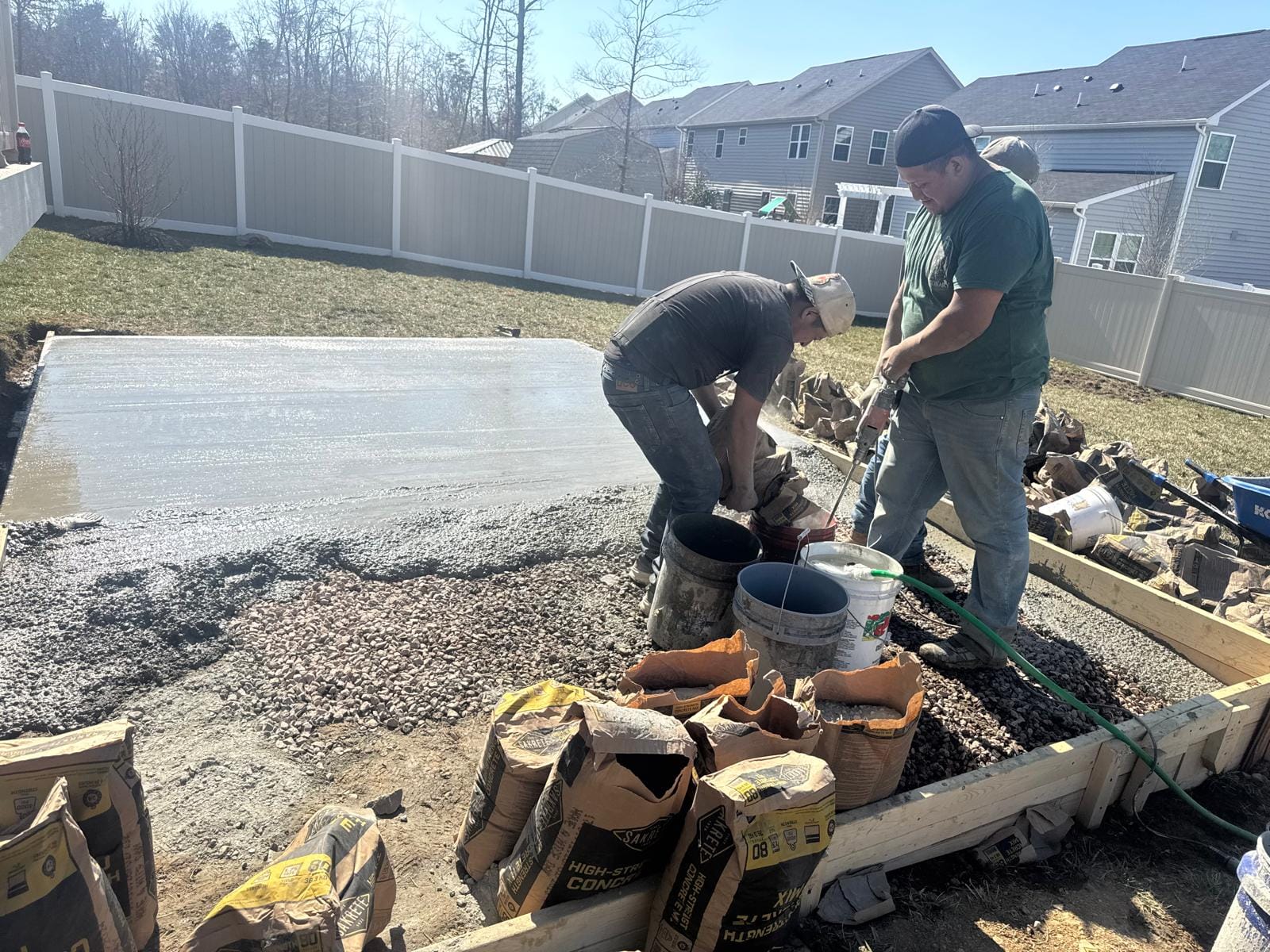 Crew preparing forms and mix for a concrete pour