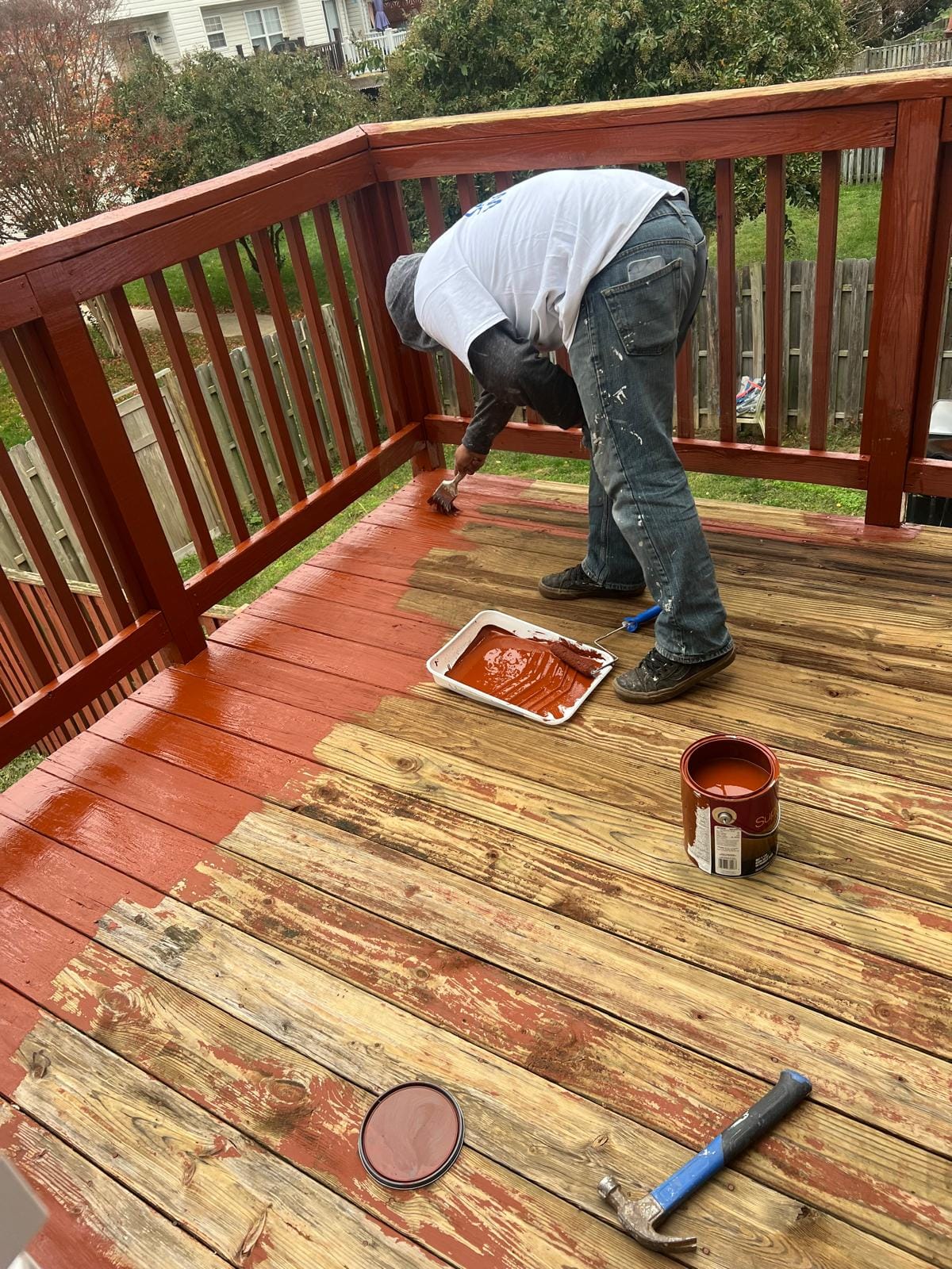 Crew member staining a wood deck