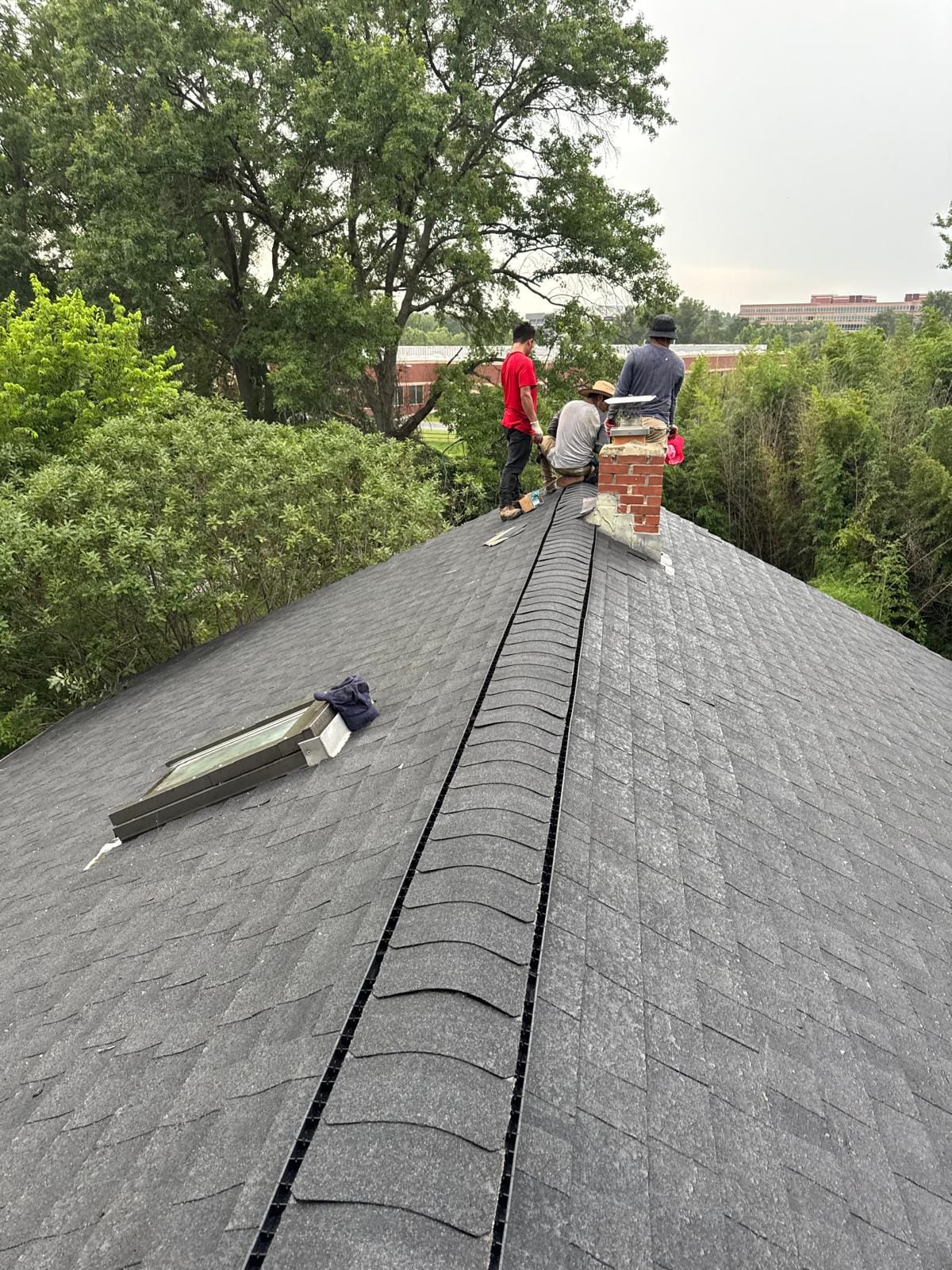 Crew working on a shingle roof