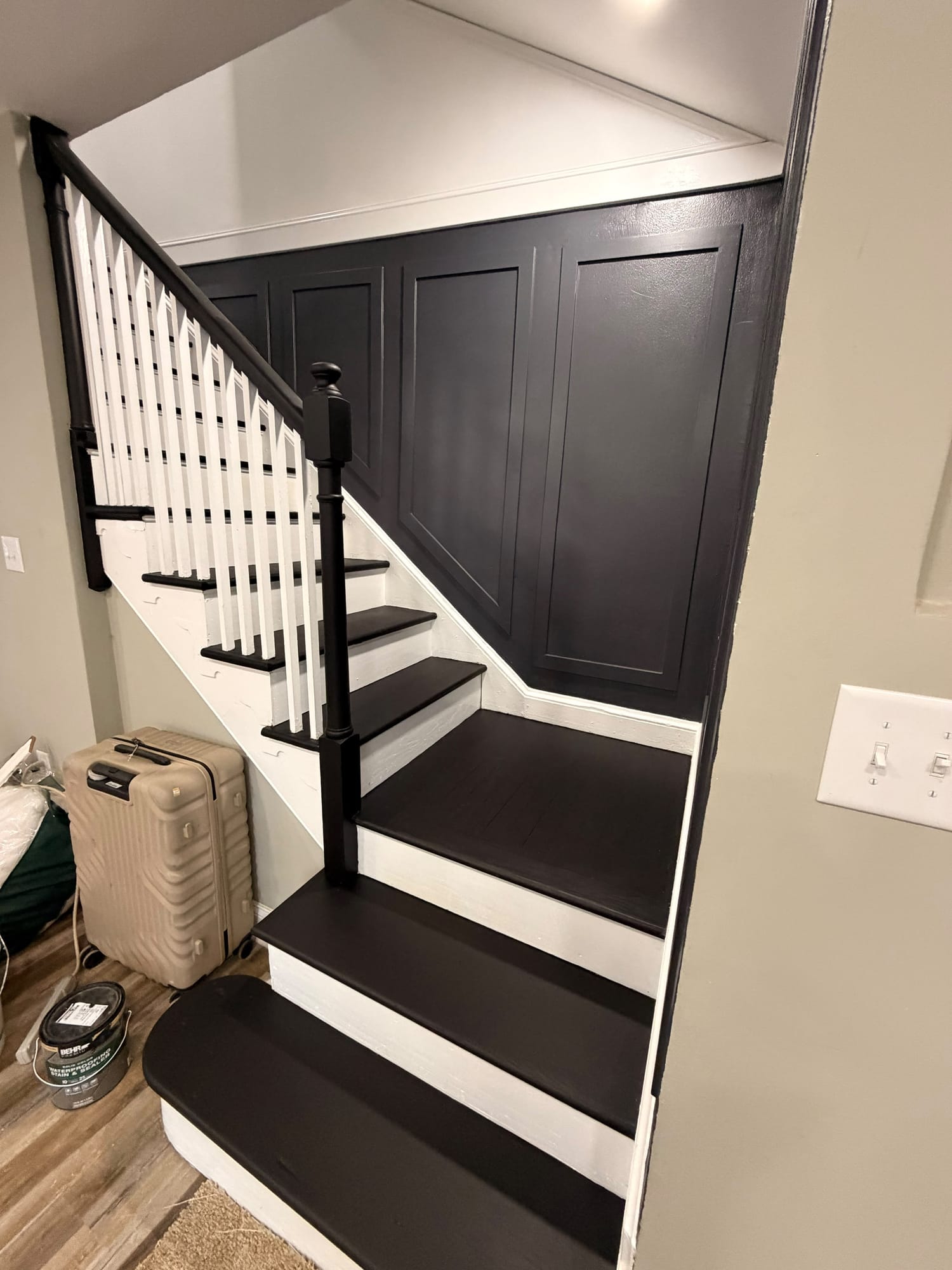 Staircase refinished in black and white with paneled wall
