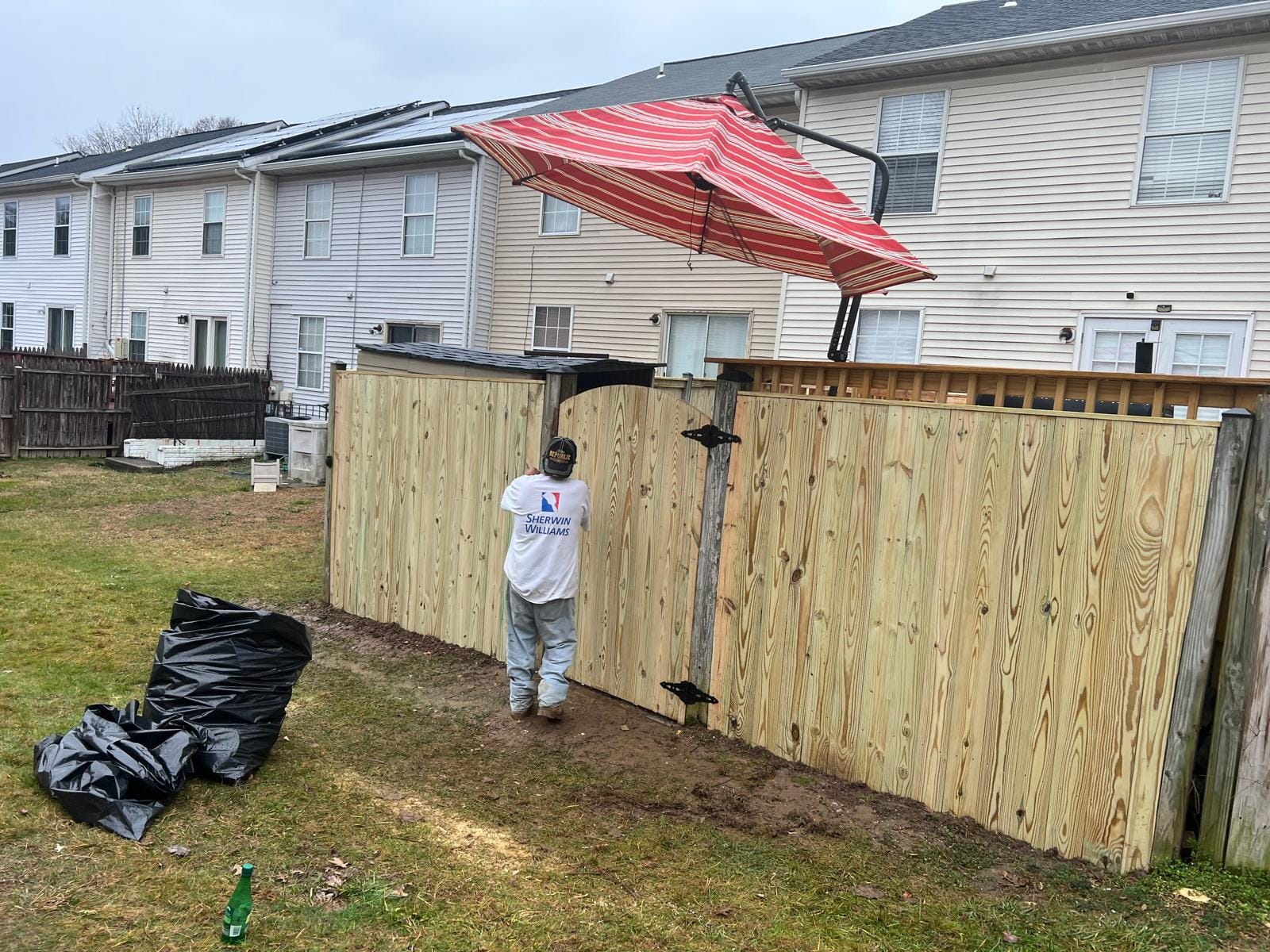 New wooden privacy fence being installed in a backyard